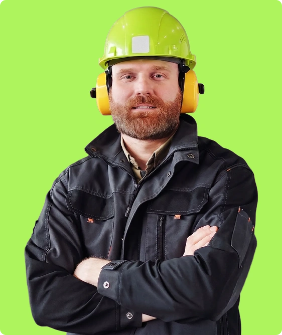 Manufacturing worker in hardhat holding gloves